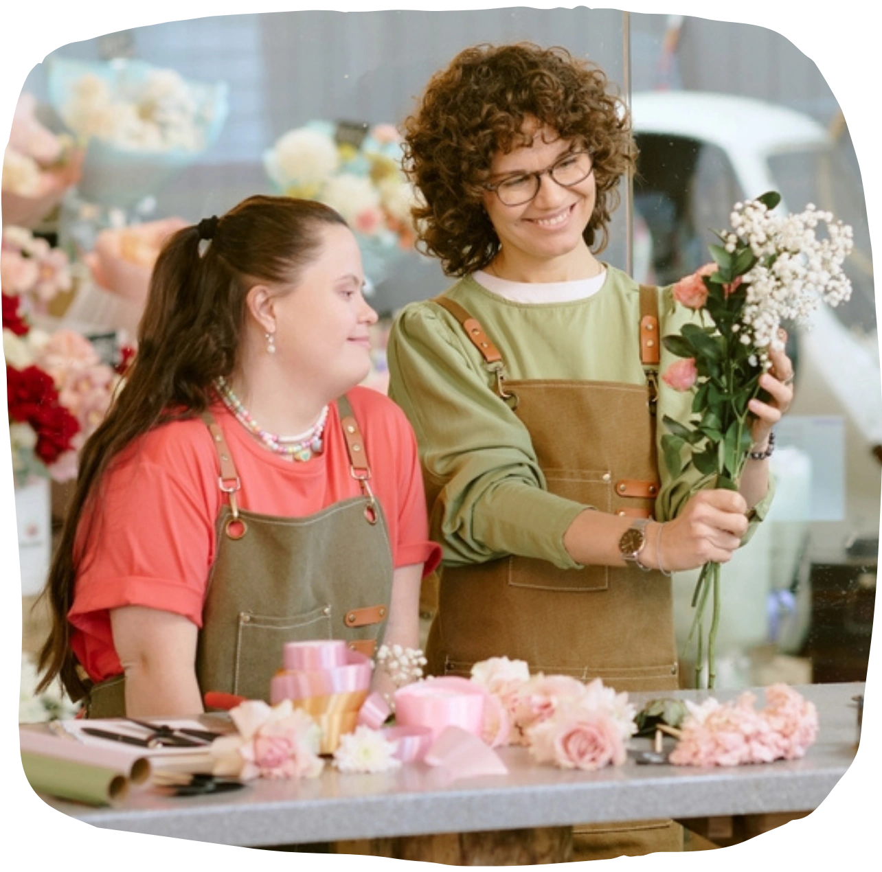 Support worker smiling with disabled woman in flower shop